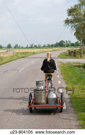 Girl on a bicycle dragging a cart with milkbottles. View Large Photo Image Stock Photography - Girl on a bicycle dragging a cart with milkbottles.. Fotosearch