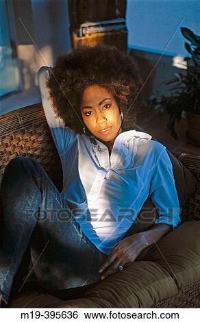 girl on a couch in the sunlight View Large Photo Image Stock Photograph - girl on a couch in the sunlight. Fotosearch