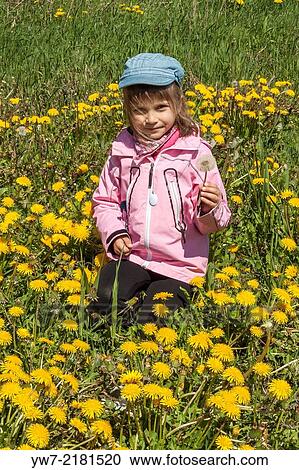 Girl on a meadow of blossoming dandelions. View Large Photo Image Stock Image - Girl on a meadow of blossoming dandelions.. Fotosearch