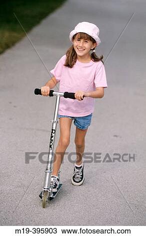 Stock Image - girl on a scooter. Fotosearch