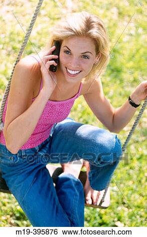 girl on a swing with cell phone View Large Photo Image Stock Photograph - girl on a swing with cell phone. Fotosearch