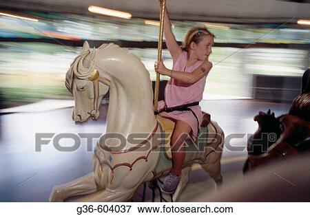 Girl on antique carousel View Large Photo Image Stock Photo - Girl on antique carousel. Fotosearch