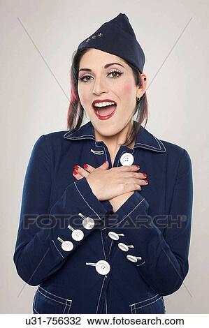 Stock Image - Girl on military outfit looking tenderly surprised at the camera. Fotosearch