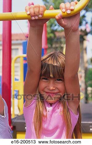 Stock Image - girl on playground bars. Fotosearch