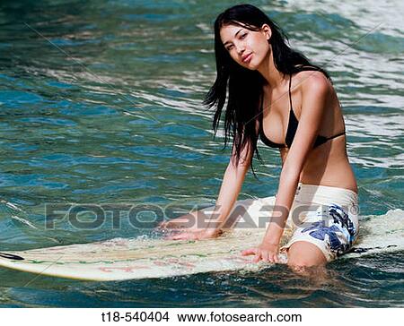 girl on surfboard in the water View Large Photo Image Picture - girl on surfboard in the water. Fotosearch