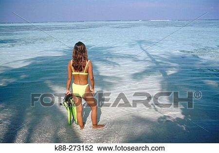 Stock Image - Girl on the beach. Meerufenfushi Island. North Male Atoll. Maldives. Fotosearch