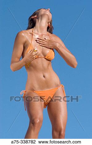 Girl on the beach putting on cream View Large Photo Image Stock Image - Girl on the beach putting on cream. Fotosearch