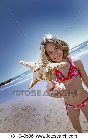 girl on the beach with starfish View Large Photo Image Stock Photograph - girl on the beach with starfish. Fotosearch
