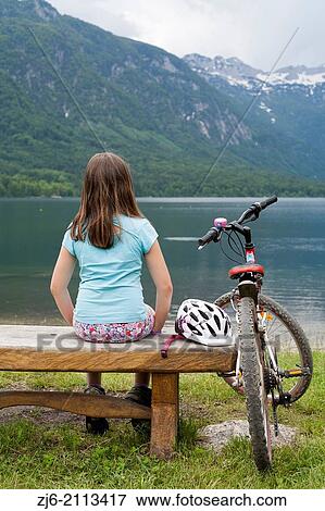 Girl on the bench by the lake, Slovenia Bohinj Gorenjska Julian Alps. View Large Photo Image Stock Photo - Girl on the bench by the lake, Slovenia Bohinj Gorenjska Julian Alps.. Fotosearch