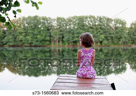 Stock Image - Girl on the pier in Lake Avral, Kirillovka, Samara Region, Russian Federation. Fotosearch