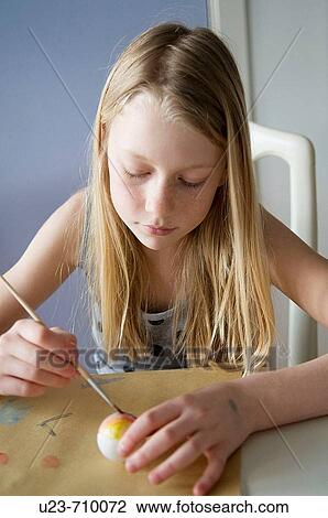 Girl painting an easter egg View Large Photo Image Stock Image - Girl painting an easter egg. Fotosearch