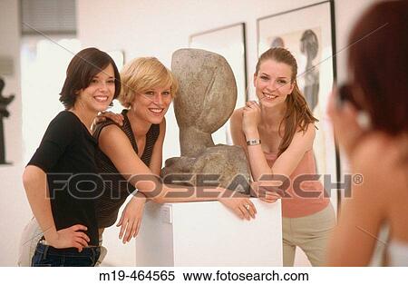 girl photographs her girlfriends at an art gallery View Large Photo Image Stock Photography - girl photographs her girlfriends at an art gallery. Fotosearch
