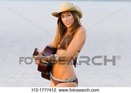 Girl playing a guitar View Large Photo Image Stock Image - Girl playing a guitar. Fotosearch