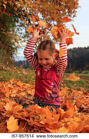 girl playing in pile of leaves, fall Zuerich, Switzerland View Large Photo Image Picture - girl playing in pile of leaves, fall Zuerich, Switzerland. Fotosearch