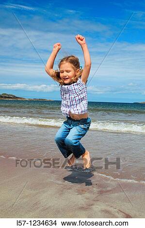 girl playing on sandy beach, Sutherland, Scotland View Large Photo Image Picture - girl playing on sandy beach, Sutherland, Scotland. Fotosearch