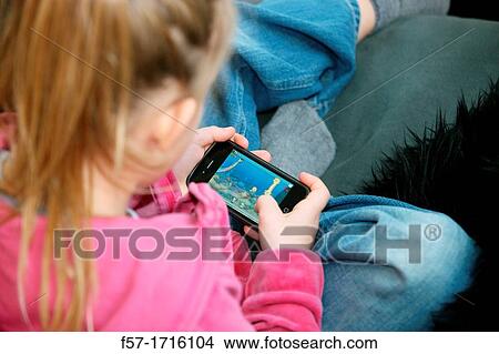 Picture - Girl playing videogame. Fotosearch
