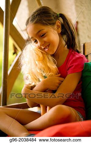 Picture - Girl playing with a dolly.. Fotosearch