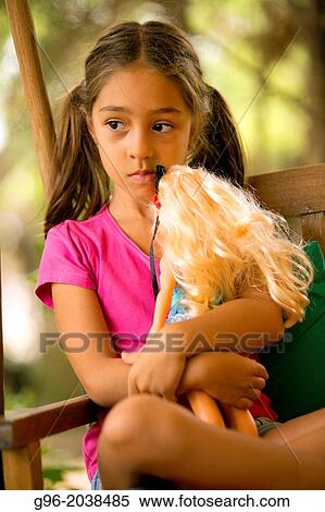 Stock Photography - Girl playing with a dolly.. Fotosearch