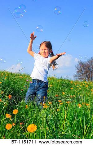 girl playing with bubbles in field of Dandelions, Zuercher Oberland, Zuerich, Switzerland View Large Photo Image Stock Image - girl playing with bubbles in field of Dandelions, Zuercher Oberland, Zuerich, Switzerland. Fotosearch
