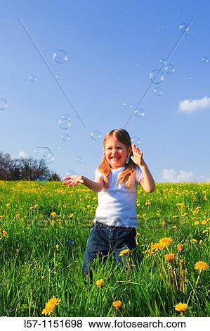 girl playing with bubbles in field of Dandelions, Zuercher Oberland, Zuerich, Switzerland View Large Photo Image Stock Photo - girl playing with bubbles in field of Dandelions, Zuercher Oberland, Zuerich, Switzerland. Fotosearch