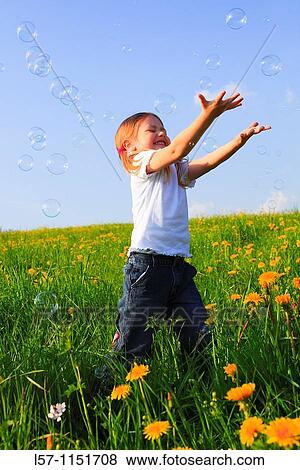 girl playing with bubbles in field of Dandelions, Zuercher Oberland, Zuerich, Switzerland View Large Photo Image Stock Photo - girl playing with bubbles in field of Dandelions, Zuercher Oberland, Zuerich, Switzerland. Fotosearch