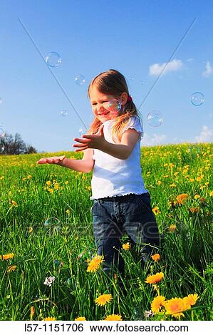 girl playing with bubbles in field of Dandelions, Zuercher Oberland, Zuerich, Switzerland View Large Photo Image Stock Photograph - girl playing with bubbles in field of Dandelions, Zuercher Oberland, Zuerich, Switzerland. Fotosearch