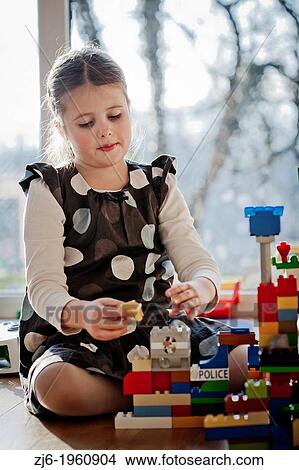 Girl playing with cubes indoor. View Large Photo Image Picture - Girl playing with cubes indoor.. Fotosearch