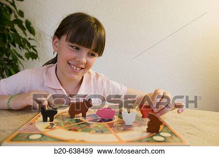 Girl playing with farm animal figures View Large Photo Image Stock Photo - Girl playing with farm animal figures. Fotosearch