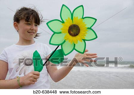 Girl playing with flower-shaped weather vane View Large Photo Image Stock Photo - Girl playing with flower-shaped weather vane. Fotosearch