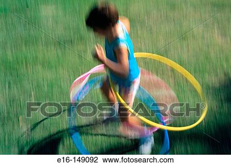 Girl playing with hula hoops View Large Photo Image Stock Image - Girl playing with hula hoops. Fotosearch