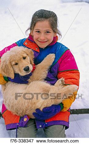Girl playing with puppy in snow View Large Photo Image Stock Photo - Girl playing with puppy in snow. Fotosearch