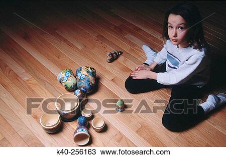 Girl playing with Russian nesting dolls on the floor View Large Photo Image Stock Image - Girl playing with Russian nesting dolls on the floor. Fotosearch