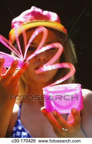 Girl playing with slinky toy View Large Photo Image Stock Photograph - Girl playing with slinky toy. Fotosearch