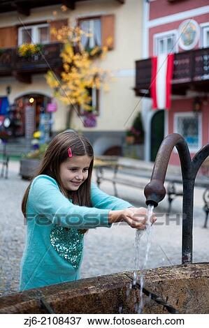 Girl playing with water. Hallstatt Austria. View Large Photo Image Stock Photo - Girl playing with water. Hallstatt Austria.. Fotosearch