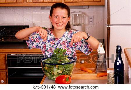 Girl preparing a salad View Large Photo Image Stock Photo - Girl preparing a salad. Fotosearch