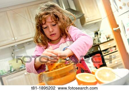 Girl preparing orange juice View Large Photo Image Stock Image - Girl preparing orange juice. Fotosearch