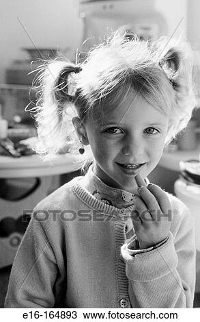 Stock Image - Girl putting on pretend makeup. Fotosearch