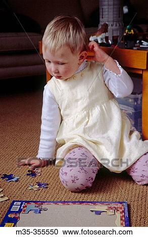 Girl puzzled over puzzle View Large Photo Image Stock Image - Girl puzzled over puzzle. Fotosearch