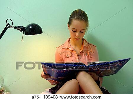 Girl reading a book View Large Photo Image Stock Photo - Girl reading a book. Fotosearch