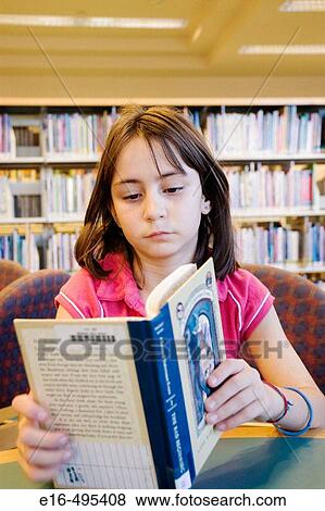 Girl reading in library View Large Photo Image Stock Photo - Girl reading in library. Fotosearch