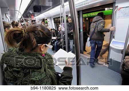 Girl reading in the subway, Barcelona, Catalonia, Spain View Large Photo Image Stock Photography - Girl reading in the subway, Barcelona, Catalonia, Spain. Fotosearch