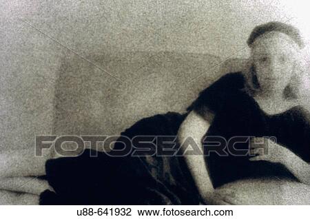 Girl reclining on couch. View Large Photo Image Stock Image - Girl reclining on couch.. Fotosearch