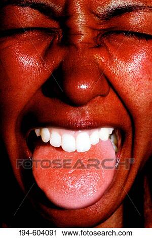 Stock Image - Girl, red face, red tongue. Digitally manipulated image. Fotosearch