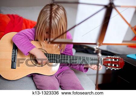 Girl rehearsing with guitar View Large Photo Image Stock Photograph - Girl rehearsing with guitar. Fotosearch