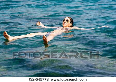Girl relaxing into the sea View Large Photo Image Stock Photo - Girl relaxing into the sea. Fotosearch