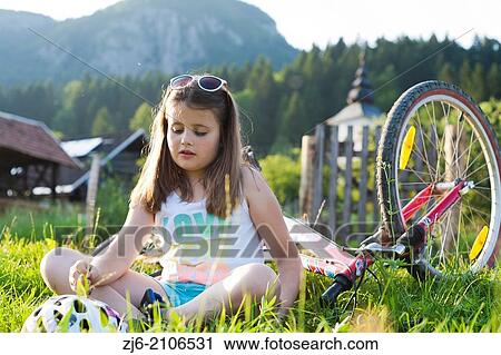 Stock Image - Girl resting and enjoying summer vacations in beautiful countryside, Bohinj Slovenia.. Fotosearch