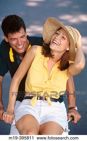 girl riding on the handle bars of her boyfriends bicycle View Large Photo Image Stock Image - girl riding on the handle bars of her boyfriends bicycle. Fotosearch
