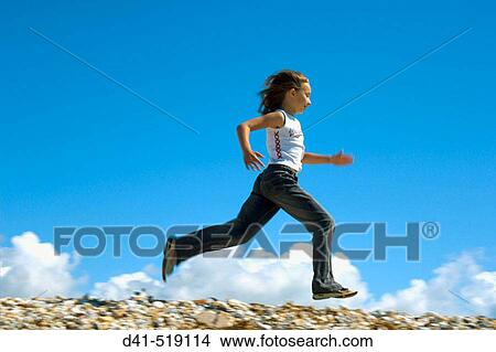 Girl running along seaside kicking View Large Photo Image Picture - Girl running along seaside kicking. Fotosearch