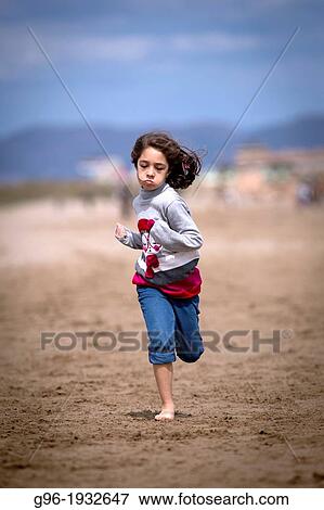 Girl running at the beach View Large Photo Image Stock Photo - Girl running at the beach. Fotosearch