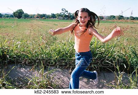 Girl running in a field View Large Photo Image Stock Image - Girl running in a field. Fotosearch